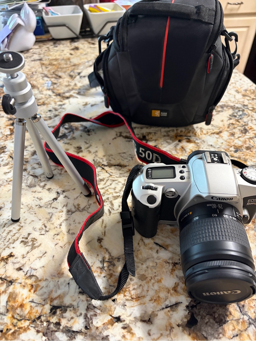Canon Silver Rebel EOS 35mm Camera with Black and Red Strap and Carry Bag